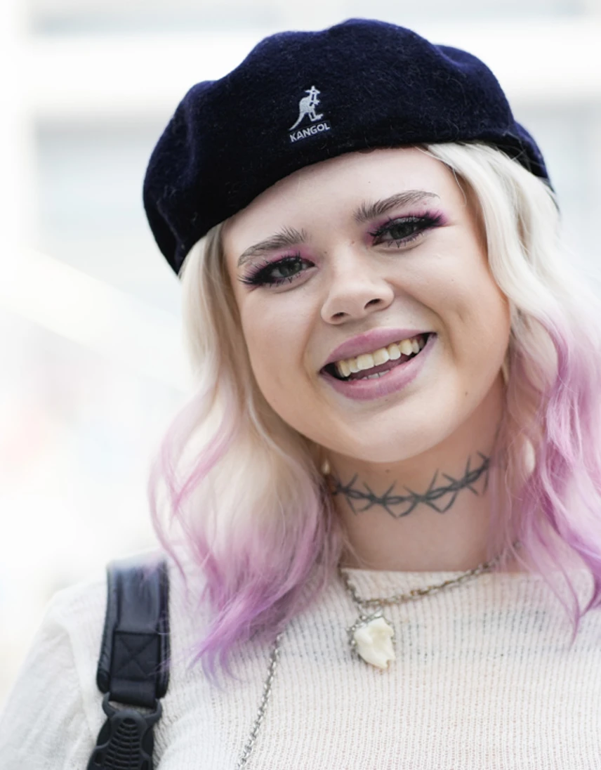 Smiling student with blonde and pink hair wearing a black Kangol beret at Glasgow Kelvin College Open Day. Smiling student with blonde and pink hair wearing a black Kangol beret at Glasgow Kelvin College Open Day.